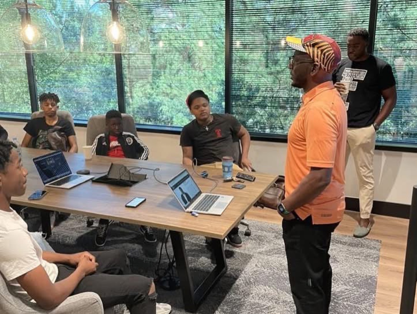 Workshop with students and a mentor at a table
