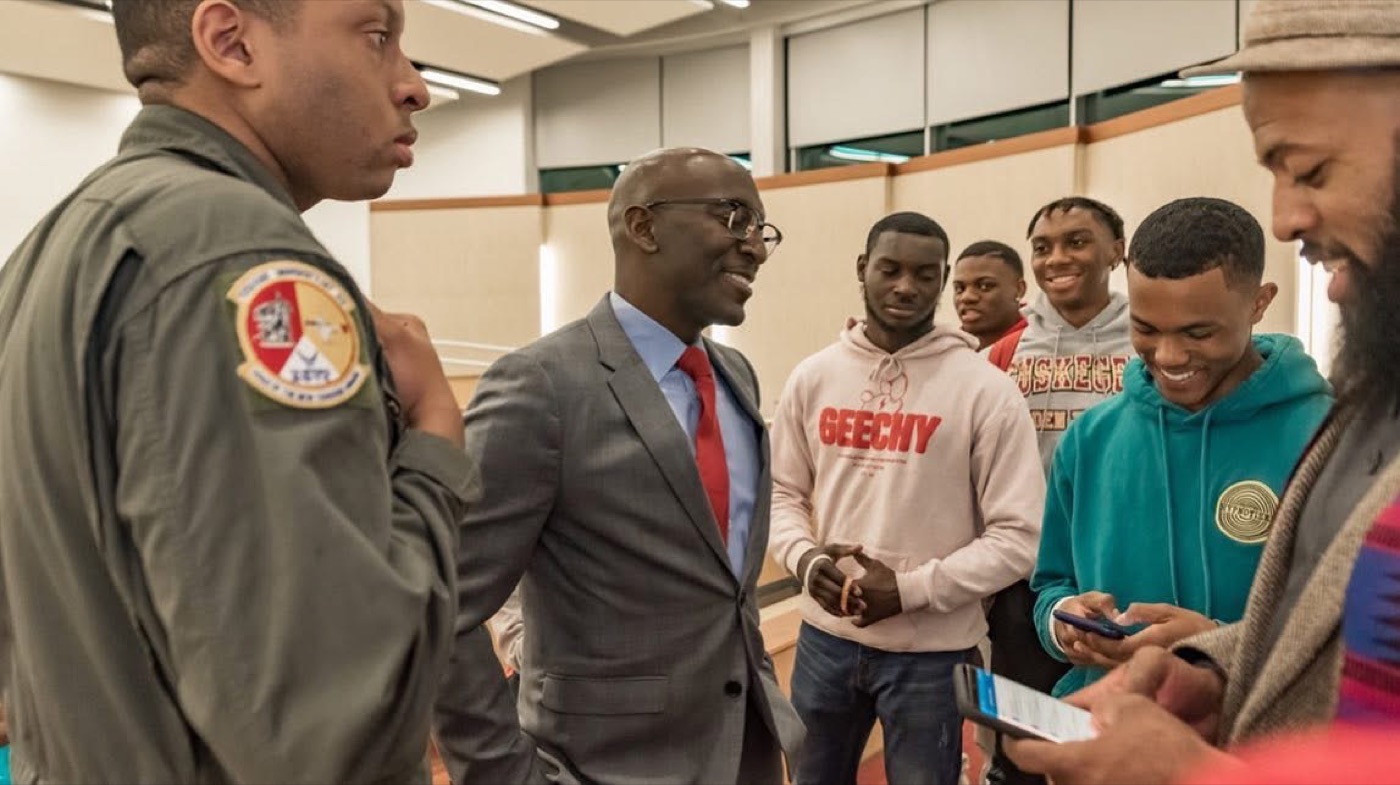 An aviation mentor speaking with students