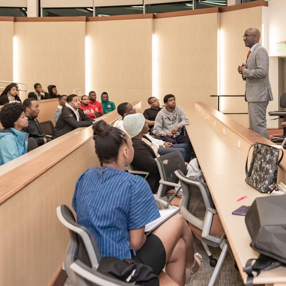 Patrick Davis leading a discussion with students in an auditorium