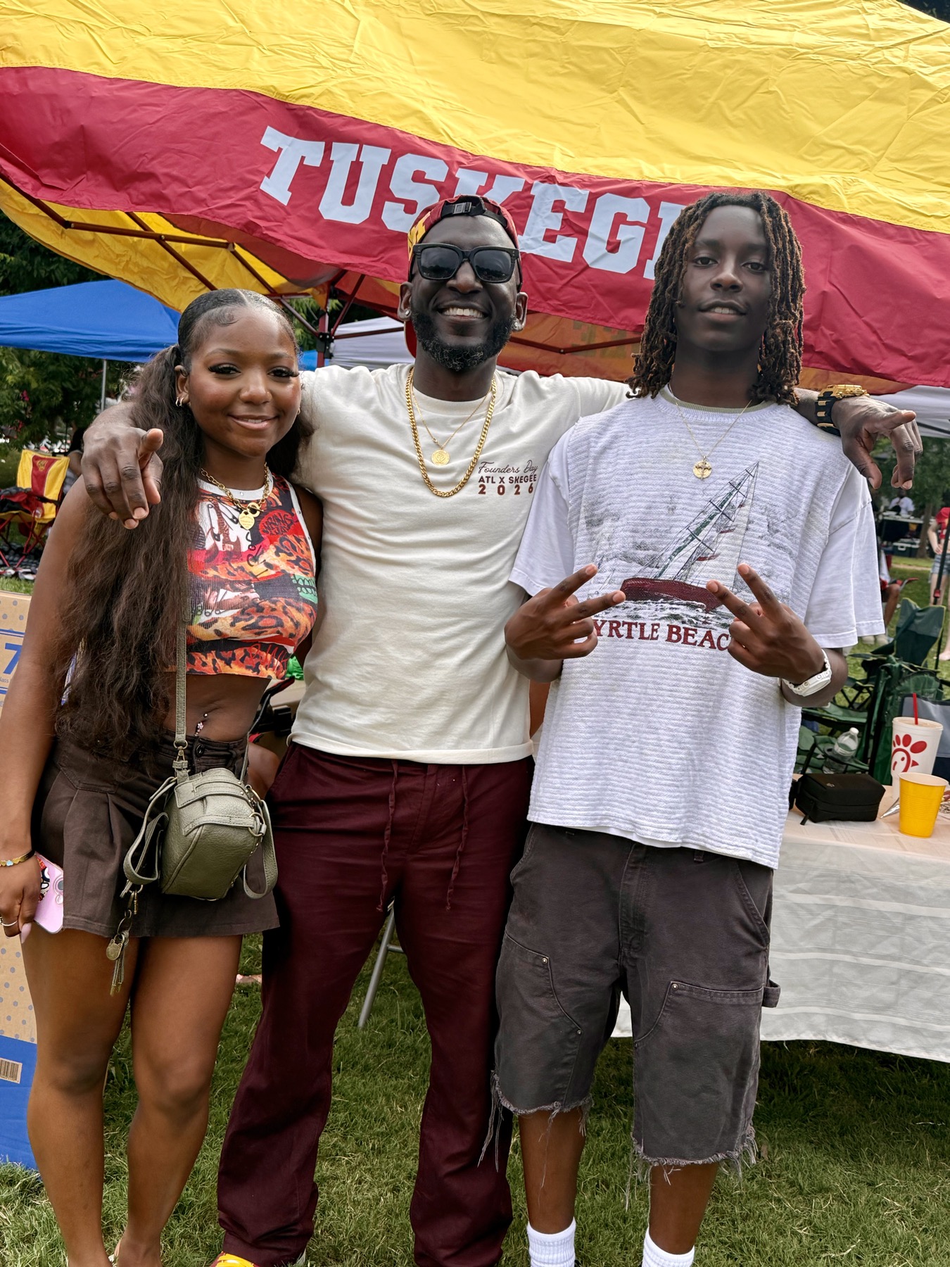 Building Legacy Foundation with students under a Tuskegee tent at the 2026 scholarship fundraiser